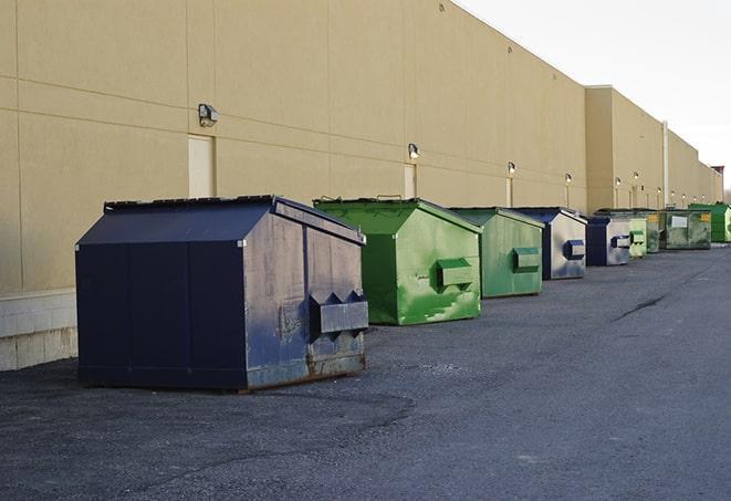 a series of colorful, utilitarian dumpsters deployed in a construction site in Cedar Lake